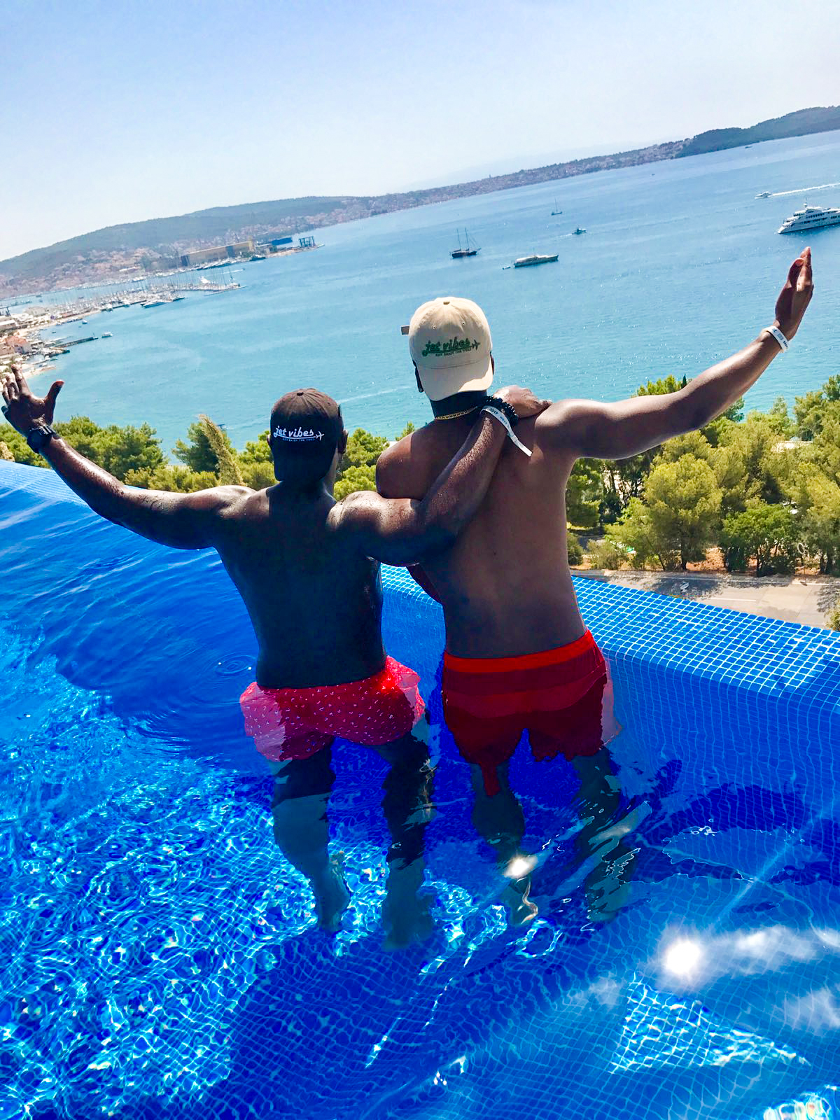 Jet Vibes lifestyle moment by infinity pool overlooking ocean view
