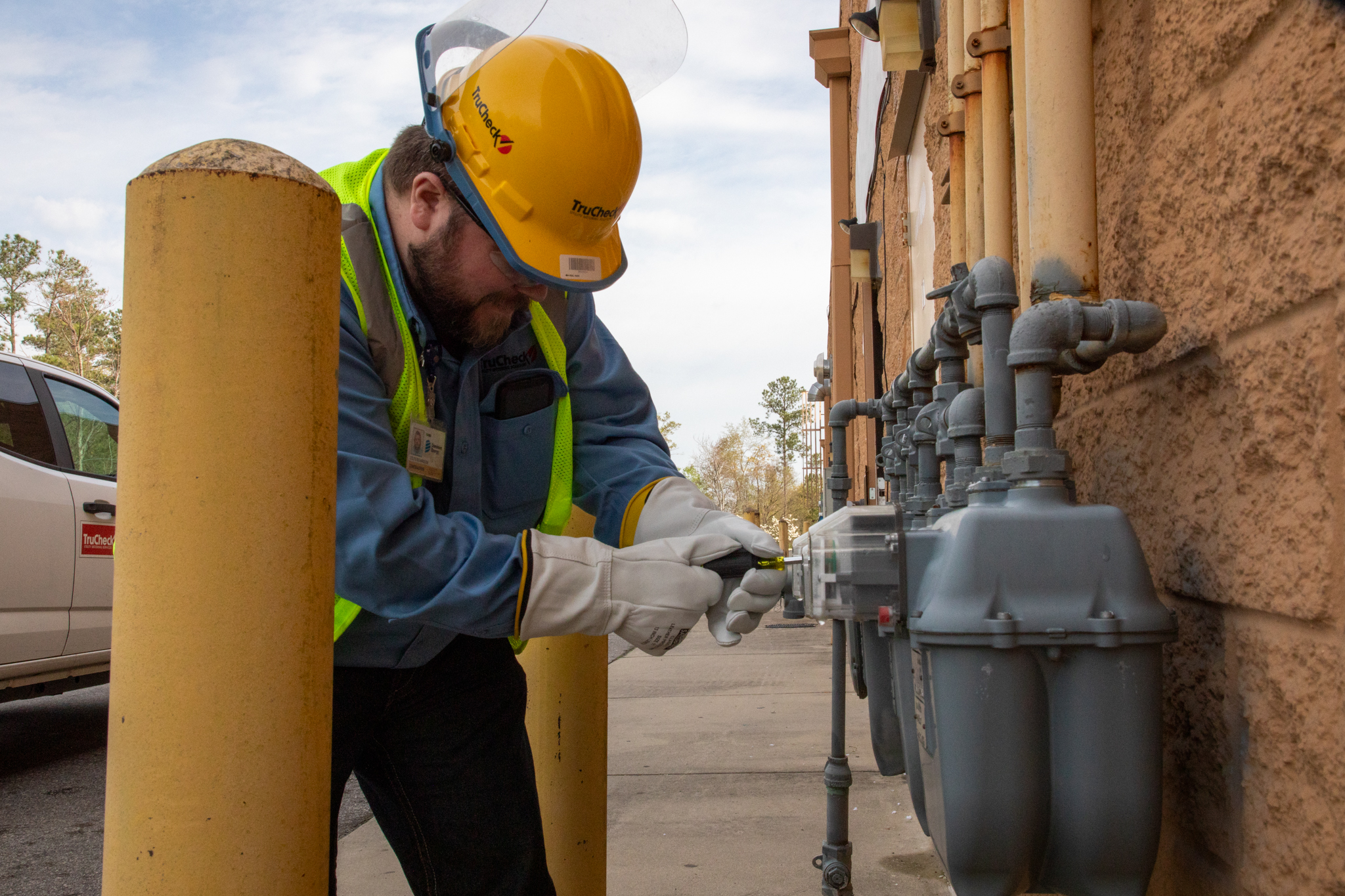 TruCheck utility technician performing meter installation and maintenance work in the field.
